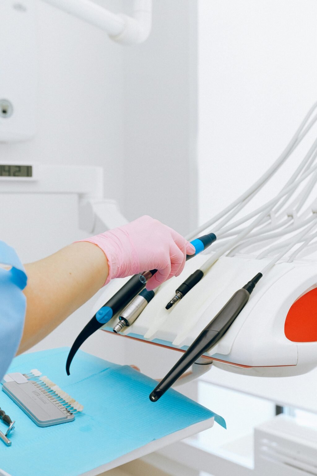 Close-up of dental tools and technology in a sterile clinic environment.