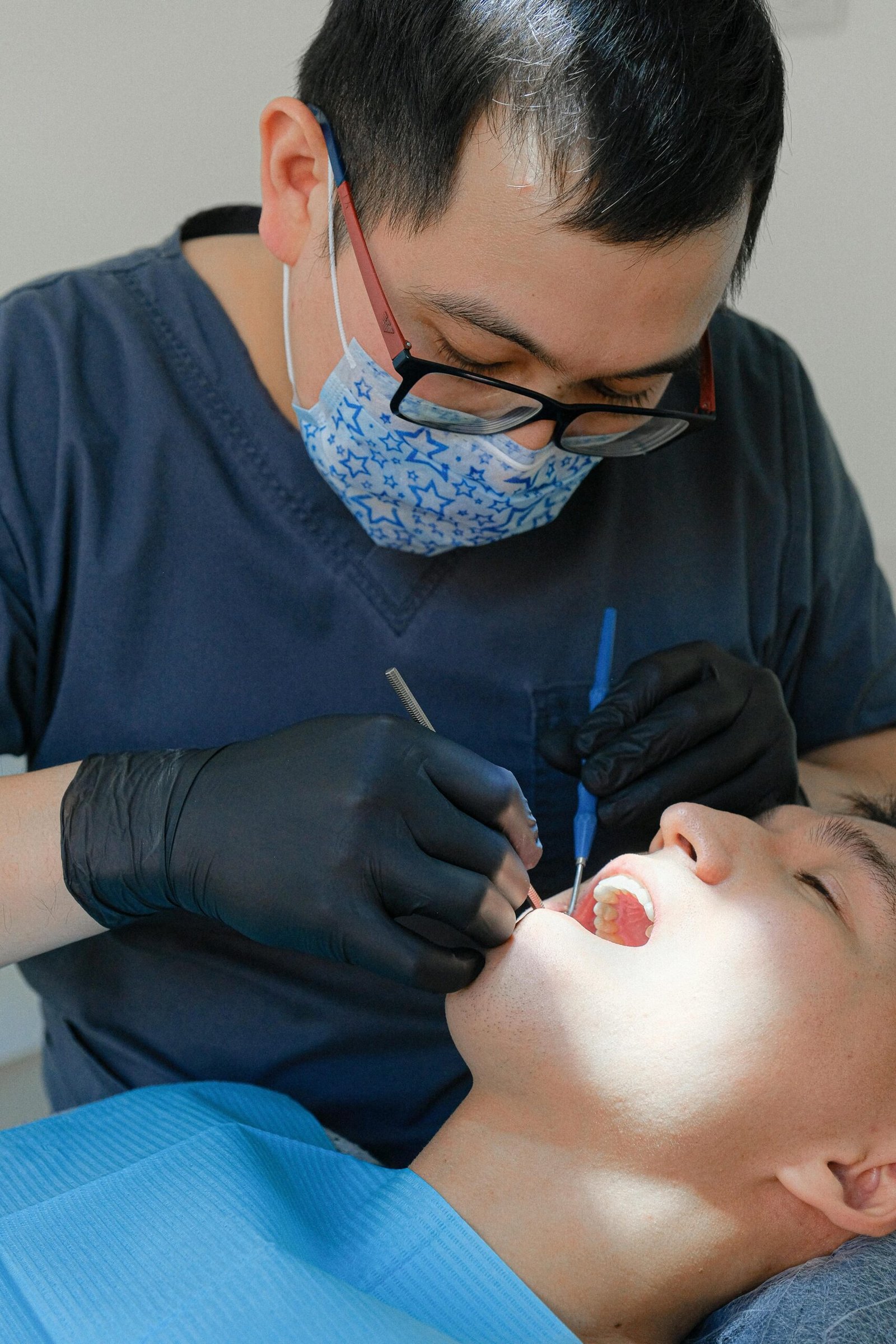 Dentist performs a dental exam on patient using advanced tools in a clinic.