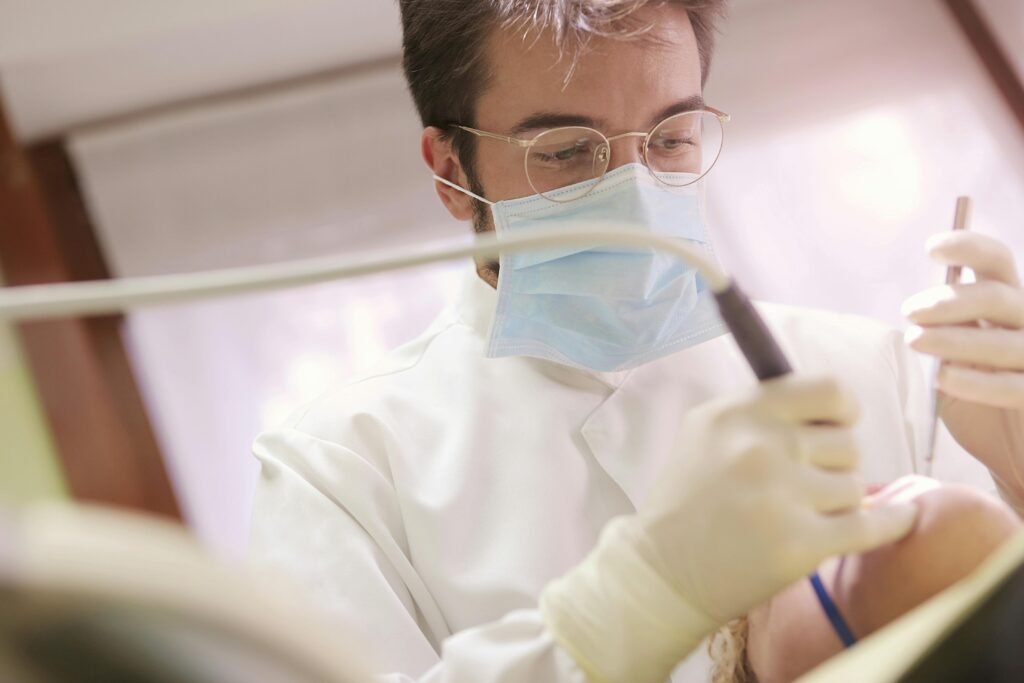 Close-up of a dentist performing a dental procedure on a patient using modern tools.