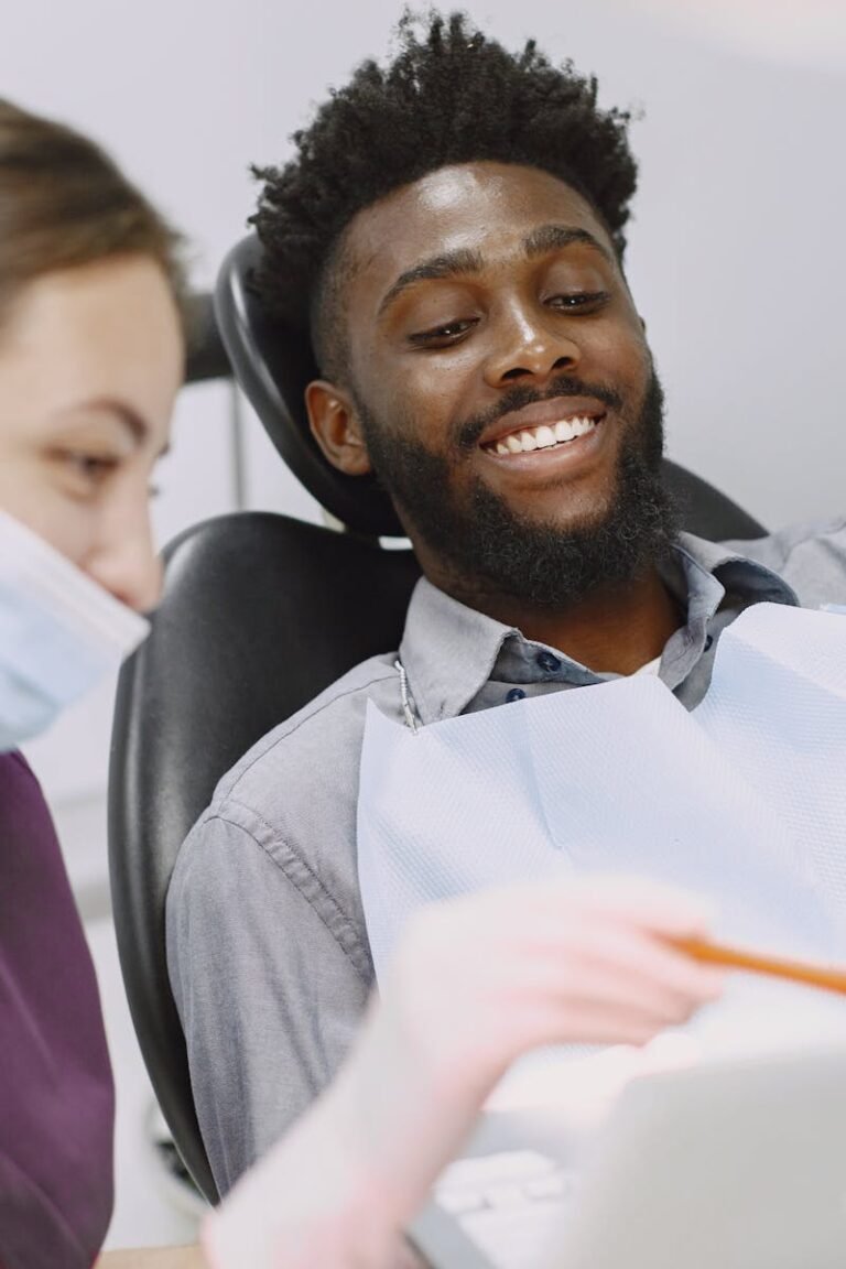 Smiling patient at the dentist's office, engaging with healthcare provider.